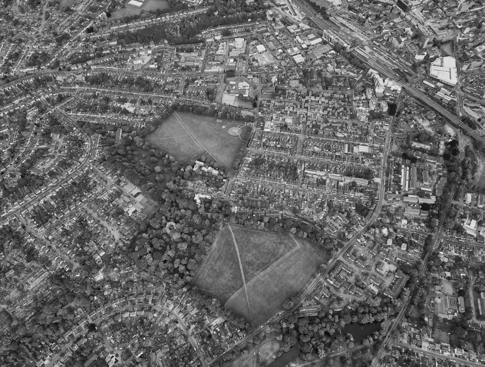 Aerial black and white photograph showcasing town layout, parks, and residential areas.